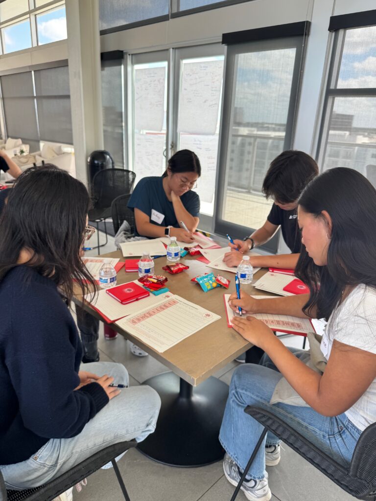 Students writing their own I Am From poems together at a workshop table