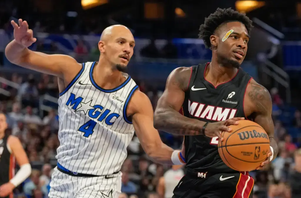 Orlando Magic guard defends a Miami Heat player driving with the ball